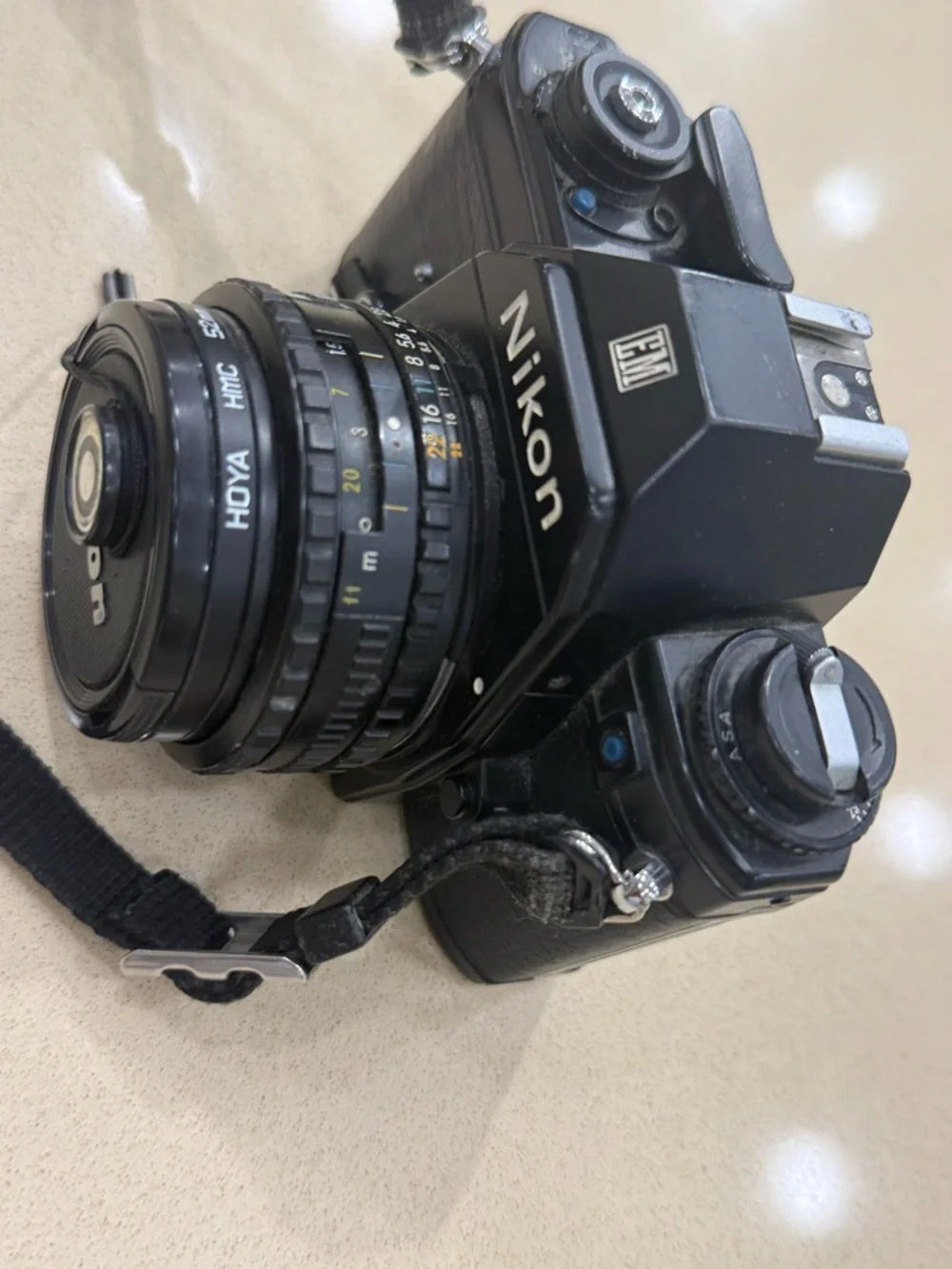 Nikon Black 35mm SLR Camera with Attached Lens and Strap